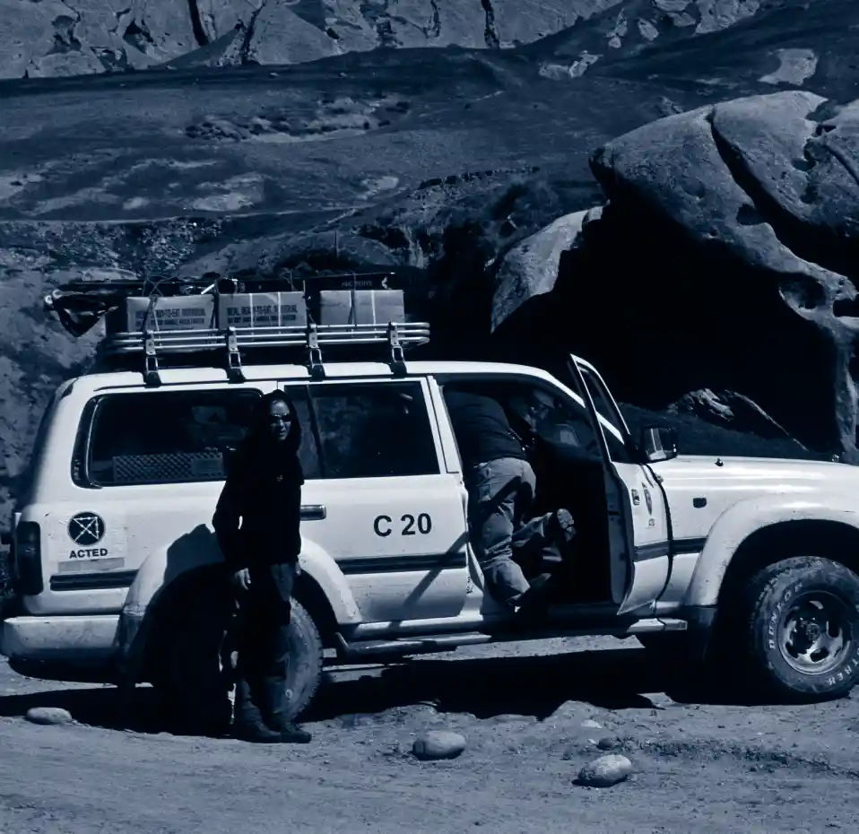 Woman outside and man inside car