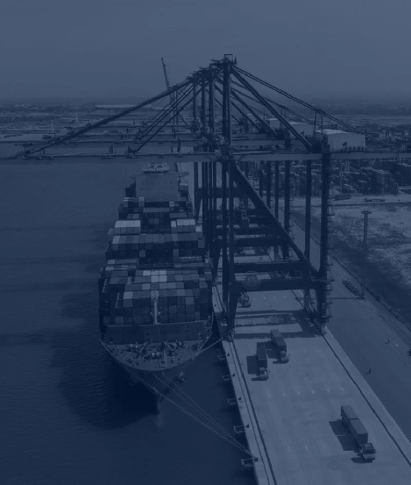 Ship carrying containers suspended in the air by a crane